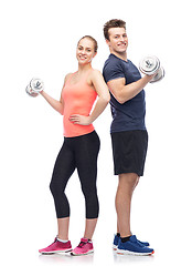 Image showing sportive man and woman with dumbbells