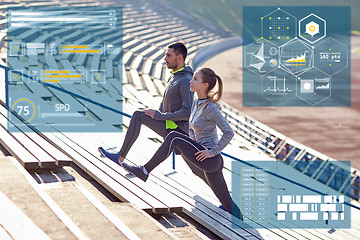 Image showing sporty couple stretching leg on stands of stadium