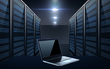 Image showing laptop computer over server room background