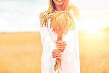 Image showing close up of happy woman with cereal spikelets