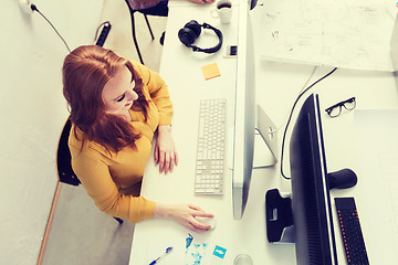 Image showing smiling businesswoman or student with computer