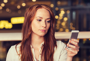 Image showing woman with smartphone and coffee at restaurant