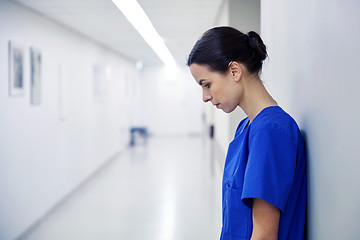Image showing sad female nurse at hospital corridor