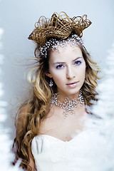 Image showing beauty young snow queen with hair crown on her head, complicate 