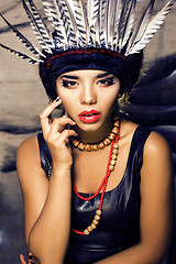 Image showing young pretty woman with make up like red indian, futher in hair,