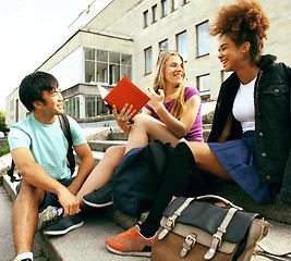 Image showing cute group of teenages at the building of university with books 