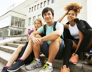 Image showing cute group of teenages at the building of university with books 