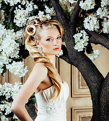 Image showing beauty young blond woman bride alone in luxury vintage interior with a lot of flowers 