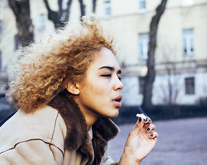 Image showing young pretty girl teenage outside smoking cigarette close up, lo