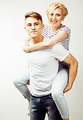 Image showing young pretty teenage couple, hipster guy with his girlfriend happy smiling and hugging isolated on white background, lifestyle people concept