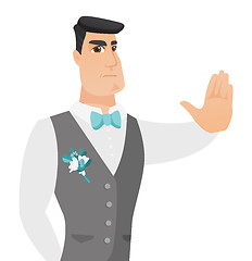 Image showing Young caucasian groom showing stop hand gesture.