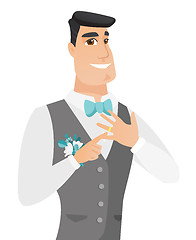 Image showing Cheerful groom showing golden ring on his finger.