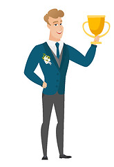 Image showing Caucasian groom holding a trophy.