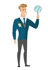 Image showing Caucasian groom holding hand mirror.