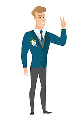 Image showing Caucasian groom showing the victory gesture.