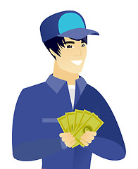Image showing Young asian mechanic holding money.