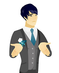 Image showing Young asian confused groom shrugging shoulders.