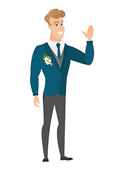 Image showing Young caucasian groom waving his hand.