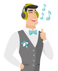 Image showing Caucasiangroom listening to music in headphones.