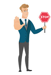 Image showing Caucasian groom holding stop road sign.