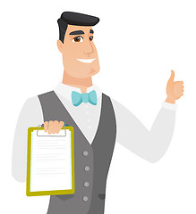 Image showing Groom holding clipboard and giving thumb up.