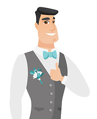 Image showing Young caucasian groom giving thumb up.