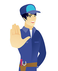 Image showing Young asian mechanic showing palm hand.