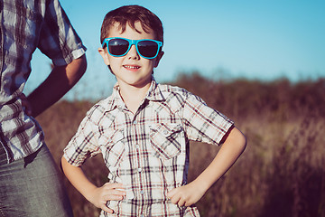 Image showing Father and son playing on the field at the day time.