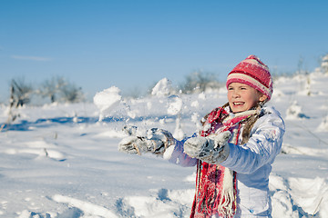 Image showing Happy little girl playing  on winter snow day.