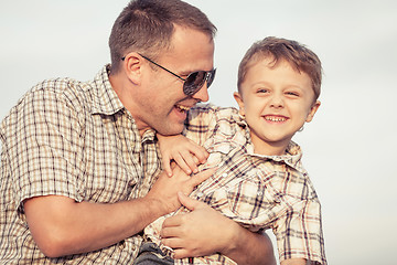 Image showing Father and son playing on the beach at the day time.