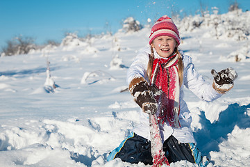 Image showing Happy little girl playing  on winter snow day.