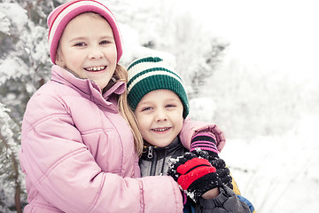 Image showing Happy little children playing  in winter snow day.