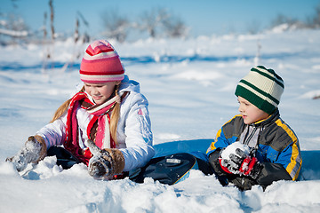 Image showing Happy little children playing  in winter snow day.