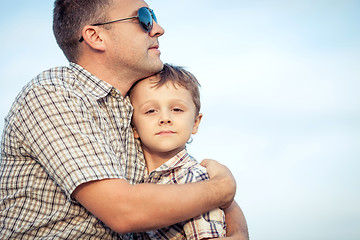 Image showing Father and son playing on the field at the day time.