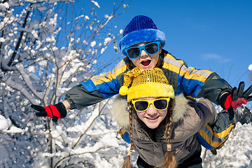 Image showing Happy little children playing  in winter snow day.