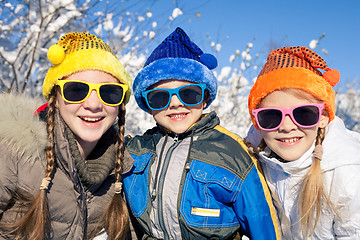 Image showing Happy little children playing  in winter snow day.