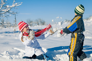 Image showing Happy little children playing  in winter snow day.