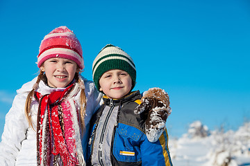 Image showing Happy little children playing  in winter snow day.