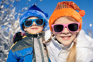 Image showing Happy little children playing  in winter snow day.