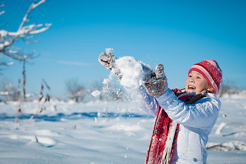 Image showing Happy little girl playing  on winter snow day.