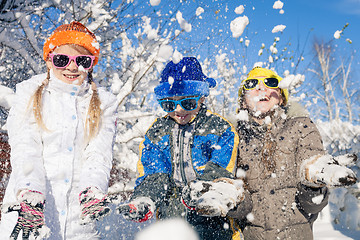 Image showing Happy little children playing  in winter snow day.