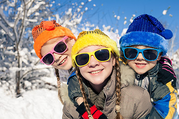 Image showing Happy little children playing  in winter snow day.