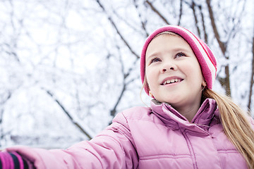 Image showing Happy little girl playing  on winter snow day.