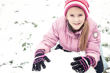 Image showing Happy little girl playing  on winter snow day.