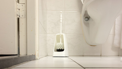 Image showing Toilet brush in a simple bathroom