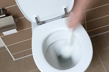 Image showing White toilet bowl in the bathroom, cleaning with toiletbrush