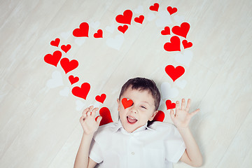 Image showing One little boy lying on the floor.