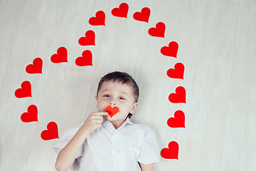 Image showing One little boy lying on the floor.