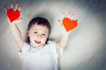 Image showing One little boy lying on the floor.