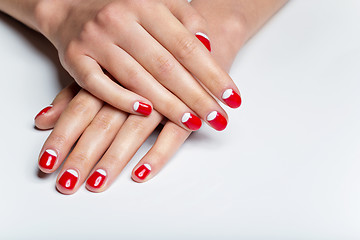 Image showing Female hands with red and white nails